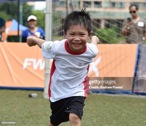 Child celebrating after scoring past Gary McAllister legend of Liverpool during a soccer school on July 22, 2017 in Hong Kong, Hong Kong.