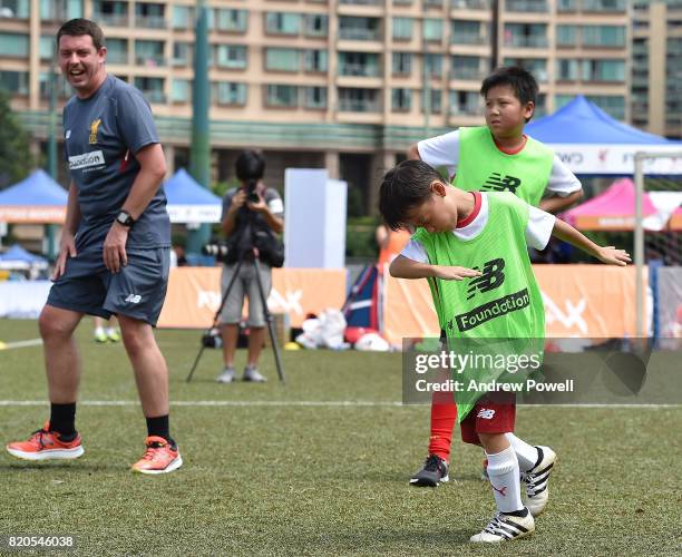 Child celebrating after scoring past Gary McAllister legend of Liverpool during a soccer school on July 22, 2017 in Hong Kong, Hong Kong.