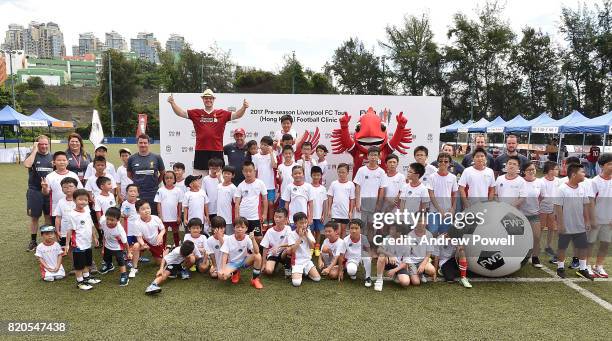 Gary McAllister legend of Liverpool, Mighty Red mascot of Liverpool, LFC Foundation coaches pose for a photograph with the children taking part of a...