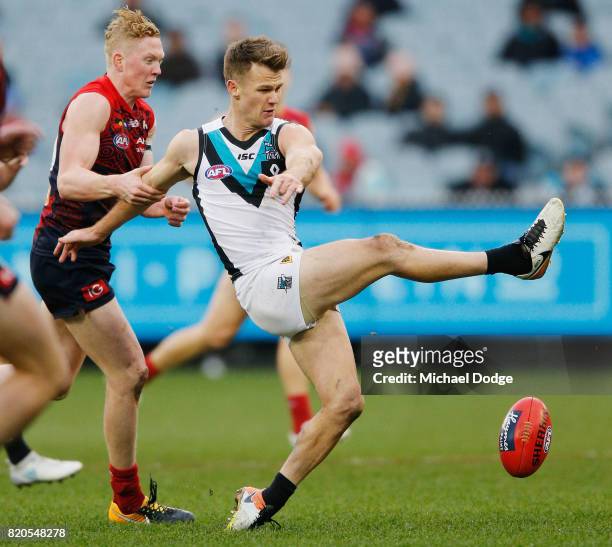 Clayton Oliver of the Demons lays a crucial tackle on Robbie Gray of the Power during the round 18 AFL match between the Melbourne Demons and the...