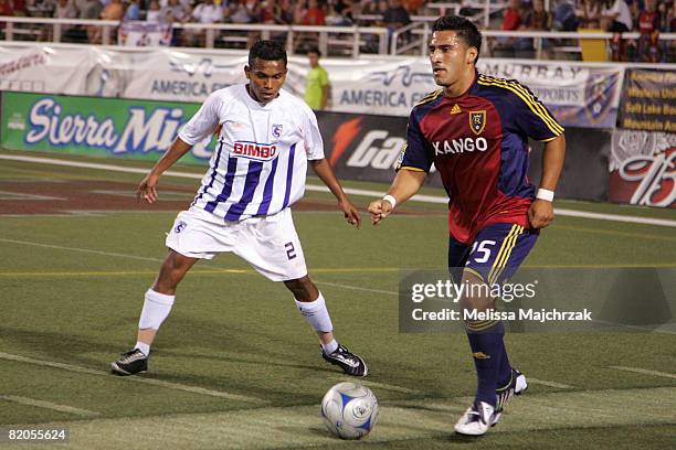 Tino Nunez of Real Salt Lake kicks the ball against Yader Balladarez of Deportivo Saprissa at Rice Eccles Stadium on July 23, 2008 in Salt Lake City,...