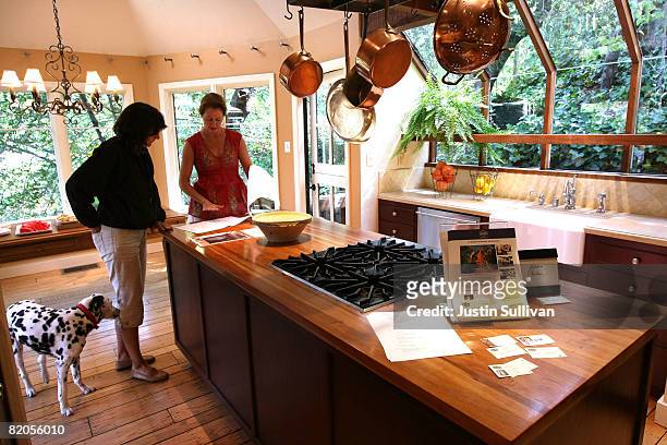 Real estate agent Jennifer Boesel shows architectural drawings to a potential home buyer at a home she is selling July 24, 2008 in San Anselmo,...
