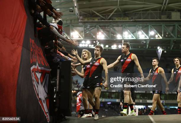 The Bombers celebrate after they defeated the Kangaroos during the round 18 AFL match between the Essendon Bombers and the North Melbourne Kangaroos...