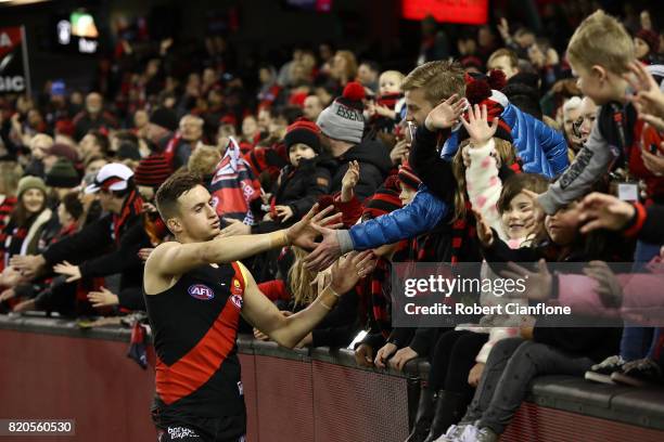 Orazio Fantasia of the Bombers celebrates with the fans after the Bombers defeated the Kangaroos during the round 18 AFL match between the Essendon...