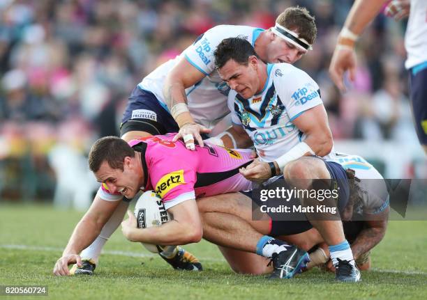 Isaah Yeo of the Panthers is tackled during the round 20 NRL match between the Penrith Panthers and the Gold Coast Titans at Pepper Stadium on July...