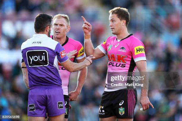 Peter Wallace and Matt Moylan of the Panthers argue with referee Gavin Badger during the round 20 NRL match between the Penrith Panthers and the Gold...