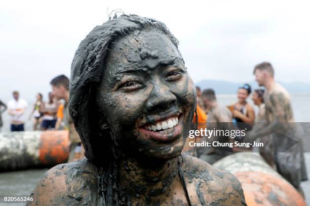 Festival-goers enjoy the mud during the annual Boryeong Mud Festival at Daecheon Beach on July 22, 2017 in Boryeong, South Korea. The mud, which is...