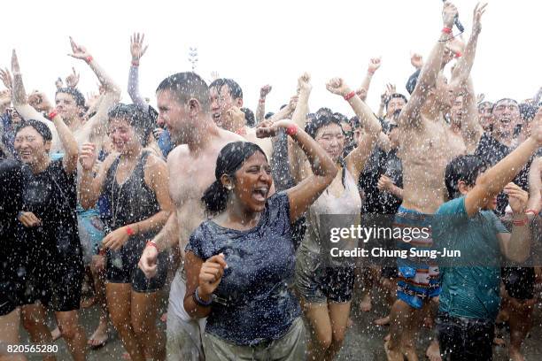 Festival-goers enjoy during the annual Boryeong Mud Festival at Daecheon Beach on July 22, 2017 in Boryeong, South Korea. The mud, which is believed...