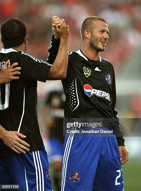 Midfielder David Beckham of L.A. Galaxy congratulates midfielder Cuauhtemoc Blanco of Chicago Fire after a goal during the 2008 Pepsi MLS All Star...