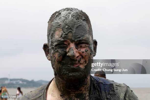 Festival-goers enjoy the mud during the annual Boryeong Mud Festival at Daecheon Beach on July 22, 2017 in Boryeong, South Korea. The mud, which is...