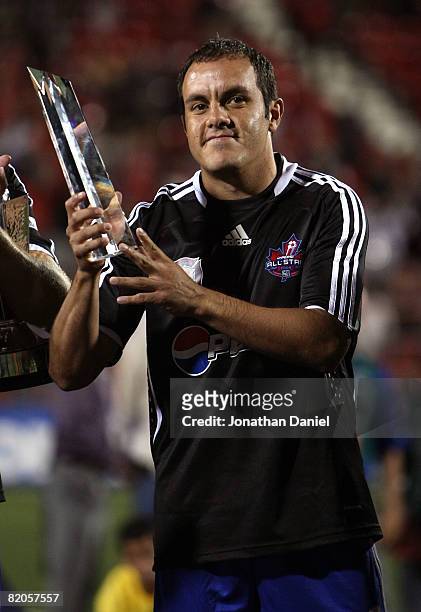 Forward Cuauhtemoc Blanco of Chicago Fire holds up the MVP trophy during the 2008 Pepsi MLS All Star Game between the MLS All Stars and West Ham...