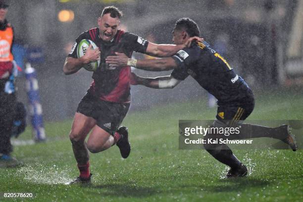 Israel Dagg of the Crusaders is tackled by Waisake Naholo of the Highlanders during the Super Rugby Quarter Final match between the Crusaders and the...