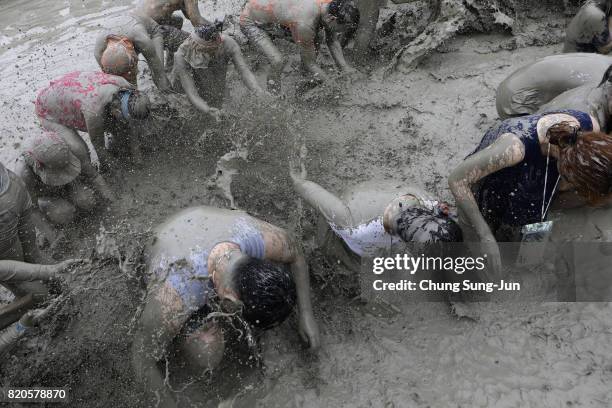 Festival-goers enjoy the mud during the annual Boryeong Mud Festival at Daecheon Beach on July 22, 2017 in Boryeong, South Korea. The mud, which is...