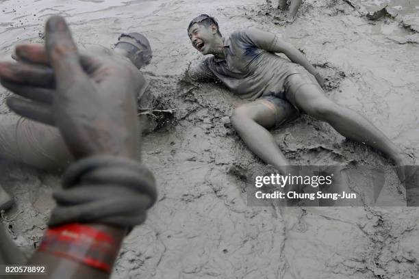 Festival-goers enjoy the mud during the annual Boryeong Mud Festival at Daecheon Beach on July 22, 2017 in Boryeong, South Korea. The mud, which is...