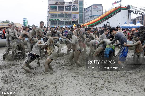 Festival-goers enjoy the mud during the annual Boryeong Mud Festival at Daecheon Beach on July 22, 2017 in Boryeong, South Korea. The mud, which is...