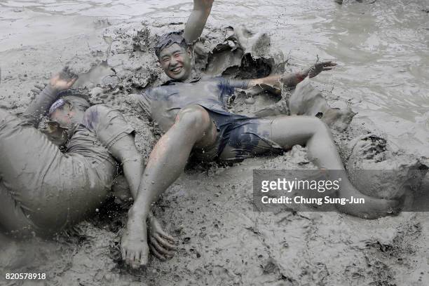 Festival-goers enjoy the mud during the annual Boryeong Mud Festival at Daecheon Beach on July 22, 2017 in Boryeong, South Korea. The mud, which is...
