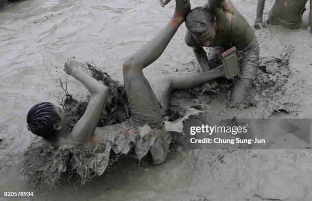 Festival-goers enjoy the mud during the annual Boryeong Mud Festival at Daecheon Beach on July 22, 2017 in Boryeong, South Korea. The mud, which is...