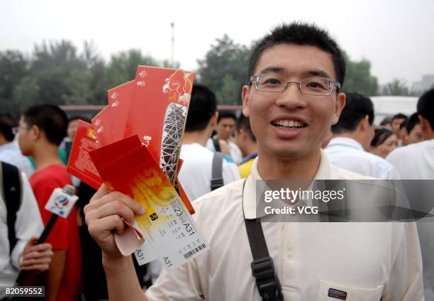 Man shows the olympic tickets he has just bought in the ticket sale booth in Beijing Olympic Center on July 25, 2008 in Beijing, China. The final...