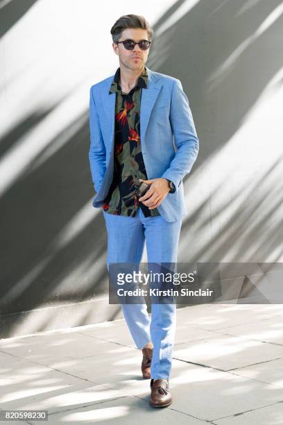 Presenter Darren Kennedy wears H and M suit and shirt, Armani watch, Specsavers sunglasses and Massimo Dutti shoes on day 3 of London Collections:...