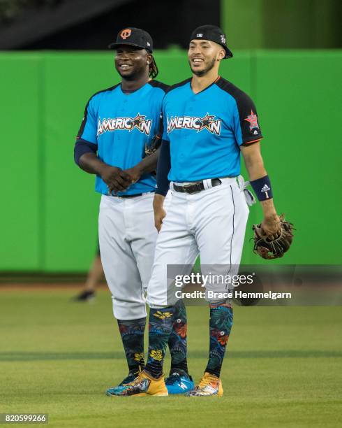 American League All-Star Carlos Correa of the Houston Astros looks on with Miguel Sano of the Minnesota Twins during Gatorade All-Star Workout Day...