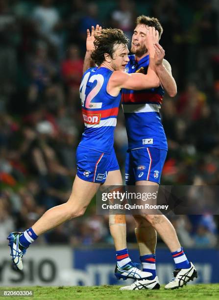 Liam Picken of the Bulldogs is congratulated by Jordan Roughead after kicking a goalduring the round 18 AFL match between the Western Bulldogs and...