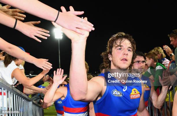 Liam Picken of the Bulldogs high fives fans after winning the round 18 AFL match between the Western Bulldogs and the Gold Coast Suns at Cazaly's...