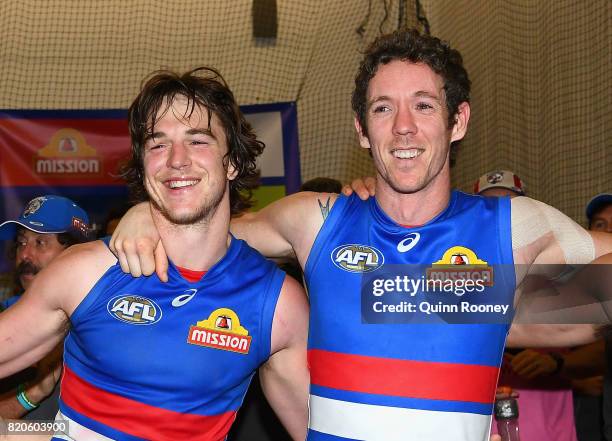 Liam Picken and Robert Murphy of the Bulldogs sing the song in the rooms after winning the round 18 AFL match between the Western Bulldogs and the...