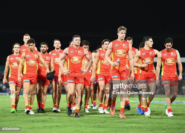 The Suns look dejected after losing the round 18 AFL match between the Western Bulldogs and the Gold Coast Suns at Cazaly's Stadium on July 22, 2017...