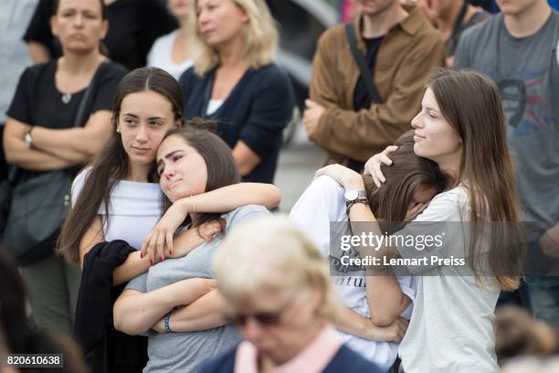 Mourners attend an event to commemorate the first anniversary of the shooting spree that one year ago left ten people dead, including the shooter, on...