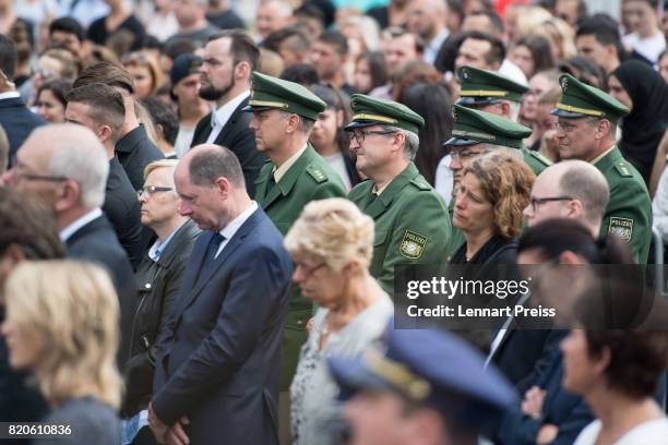 Members of the Munich Police attend an event to commemorate the first anniversary of the shooting spree that one year ago left ten people dead,...