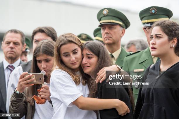 Mourners attend an event to commemorate the first anniversary of the shooting spree that one year ago left ten people dead, including the shooter, on...