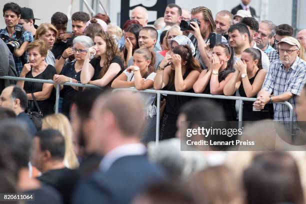 Mourners attend an event to commemorate the first anniversary of the shooting spree that one year ago left ten people dead, including the shooter, on...