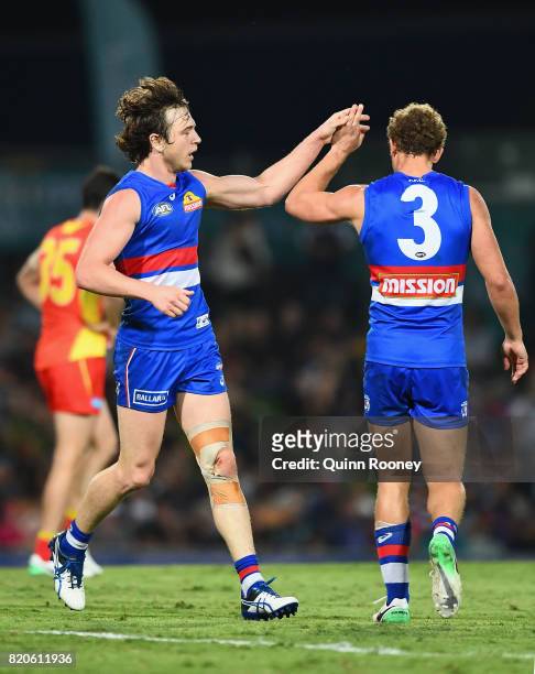 Liam Picken of the Bulldogs is congratulated by Mitch Wallis after kicking a goalduring the round 18 AFL match between the Western Bulldogs and the...