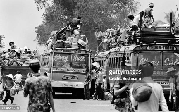 South Vietnamese residents of Nha Trang pack their belongings on buses as they get ready to flee the advancing North Vietnamese troops who are...