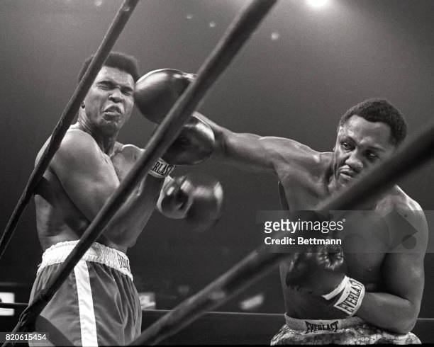 Muhammad Ali takes a hit from Joe Frazier during their heavyweight match in Madison Square Garden, March 8, 1971. Frazier won the 15-round battle by...