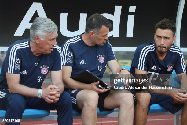 Carlo Ancelotti, head coach of FC Bayern Muenchen talk to his assistent coaches Bixente Lizarazu and Davide Ancelotti prior to the International...