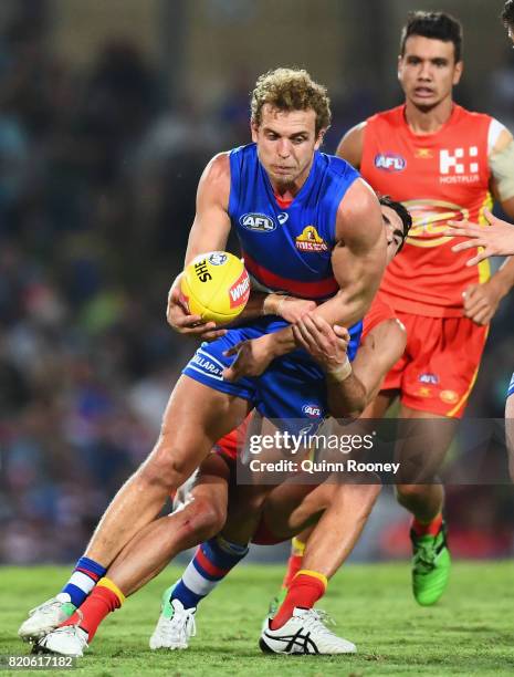 Mitch Wallis of the Bulldogs is tackled by Matt Rosa of the Suns during the round 18 AFL match between the Western Bulldogs and the Gold Coast Suns...