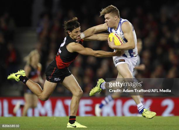 Cameron Zurhaar of the Kangaroos fends off Mark Baguley of the Bombers during the 2017 AFL round 18 match between the Essendon Bombers and the North...