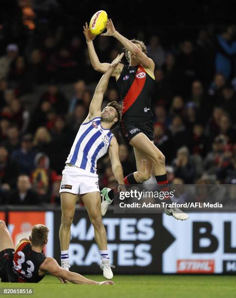 Joe Daniher of the Bombers marks the ball over Luke McDonald of the Kangaroos during the 2017 AFL round 18 match between the Essendon Bombers and the...