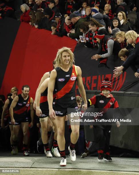 Dyson Heppell of the Bombers leads the team onto the field with kids from children's cancer charity 'Challenge' ahead of the Clash for Cancer during...