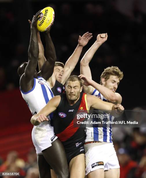 Majak Daw an dDaniel Nielson of the Kangaroos compete for the ball with Jayden Laverde and Tom Bellchambers of the Bombers during the 2017 AFL round...