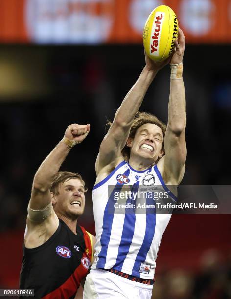 Ben Brown of the Kangaroos marks the ball over Michael Hurley of the Bombers during the 2017 AFL round 18 match between the Essendon Bombers and the...