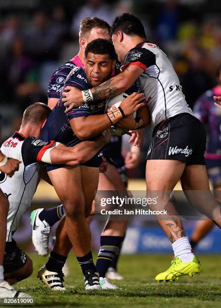 John Asiata of the Cowboys is tackled by Issac Luke and Simon Mannering of the Warriors during the round 20 NRL match between the North Queensland...