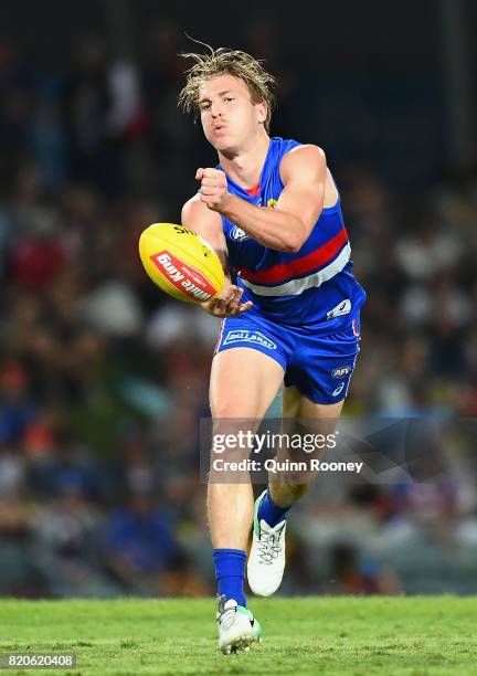 Shane Biggs of the Bulldogs handballs during the round 18 AFL match between the Western Bulldogs and the Gold Coast Suns at Cazaly's Stadium on July...
