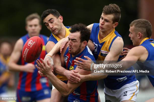 Luke Steven Tynan of Port Melbourne is tackled during the round 14 VFL match between Port Melbourne and Williamstown at North Port Oval on July 22,...