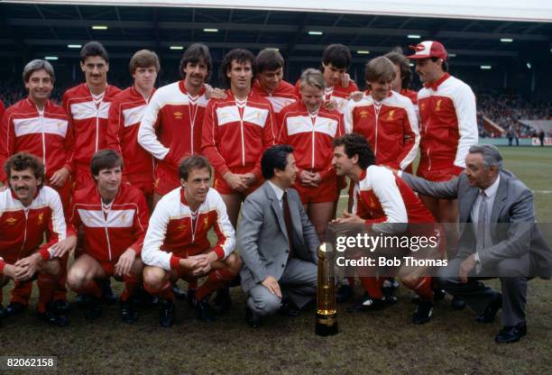 The Liverpool team pose with the Canon First Division Championship trophy and Canon Managing Director Mr Yamashita prior to their match against...