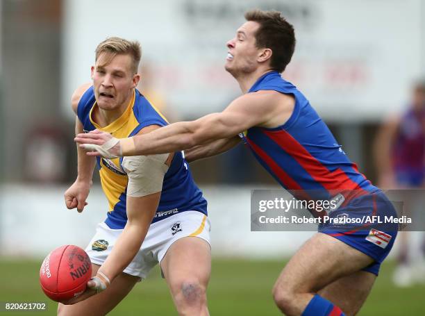 Joshua Newman of Williamstown handballs during the round 14 VFL match between Port Melbourne and Williamstown at North Port Oval on July 22, 2017 in...