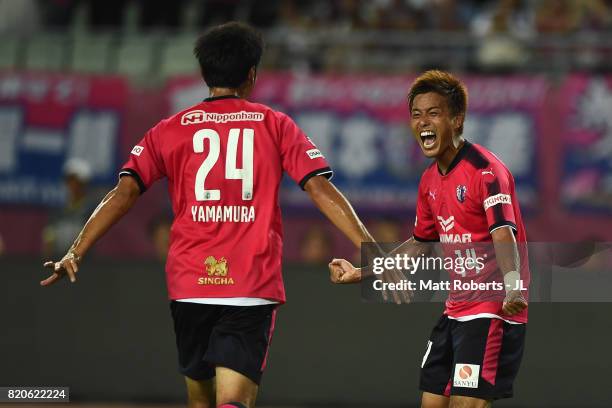 Yusuke Maruhashi of Cerezo Osaka celebrates scoring his side's fourth goal with his team mate Kazuya Yamamura during the J.League J1 match between...
