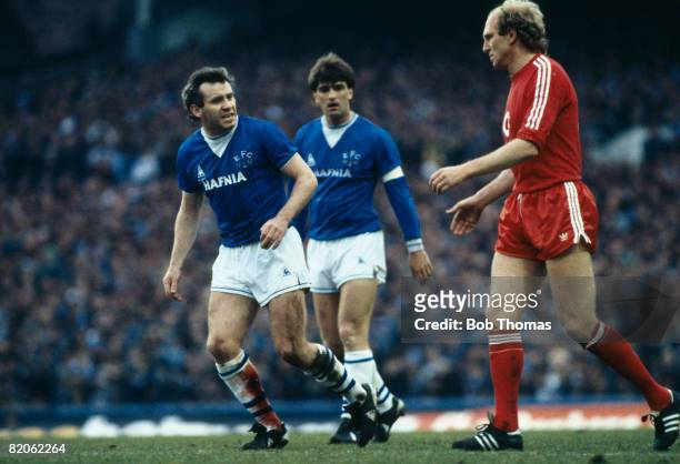 Everton's Peter Reid, with his badly gashed leg bleeding through his sock, looks angrily towards Bayern Munich's Dieter Hoeness during their European...