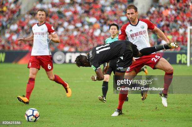 West Bromwich defender Craig Dawson tackles Crystal Palace's midfielder Wilfried Zaha during the third-place playoff match of the Premier League Asia...